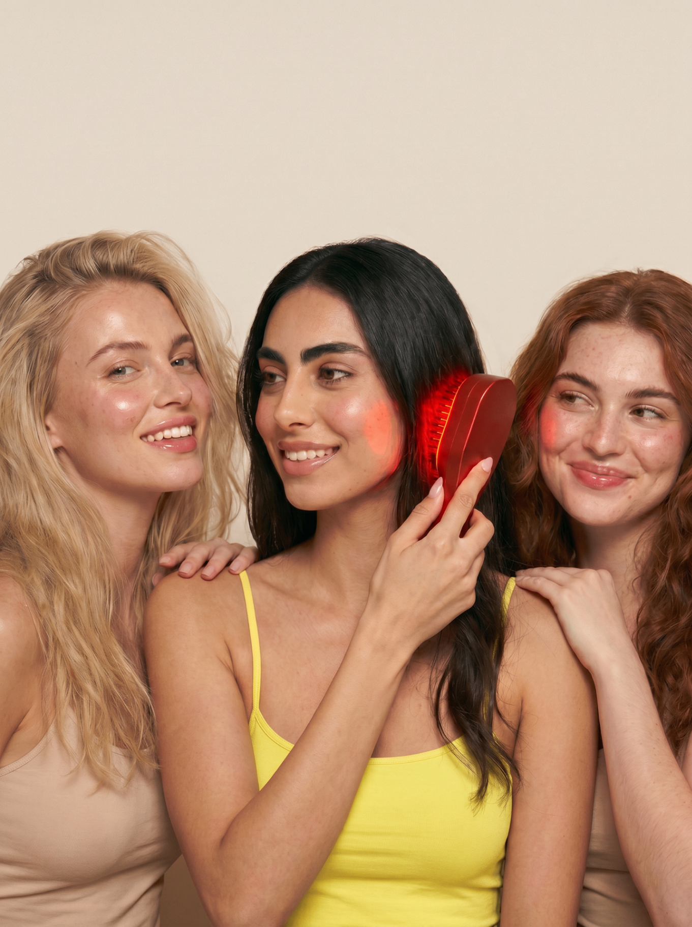 Three women using the Nova red light scalp brush together